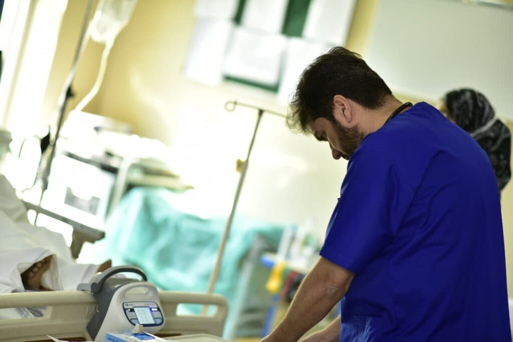Dr. Asim Rana attending to a patient in the intensive care unit