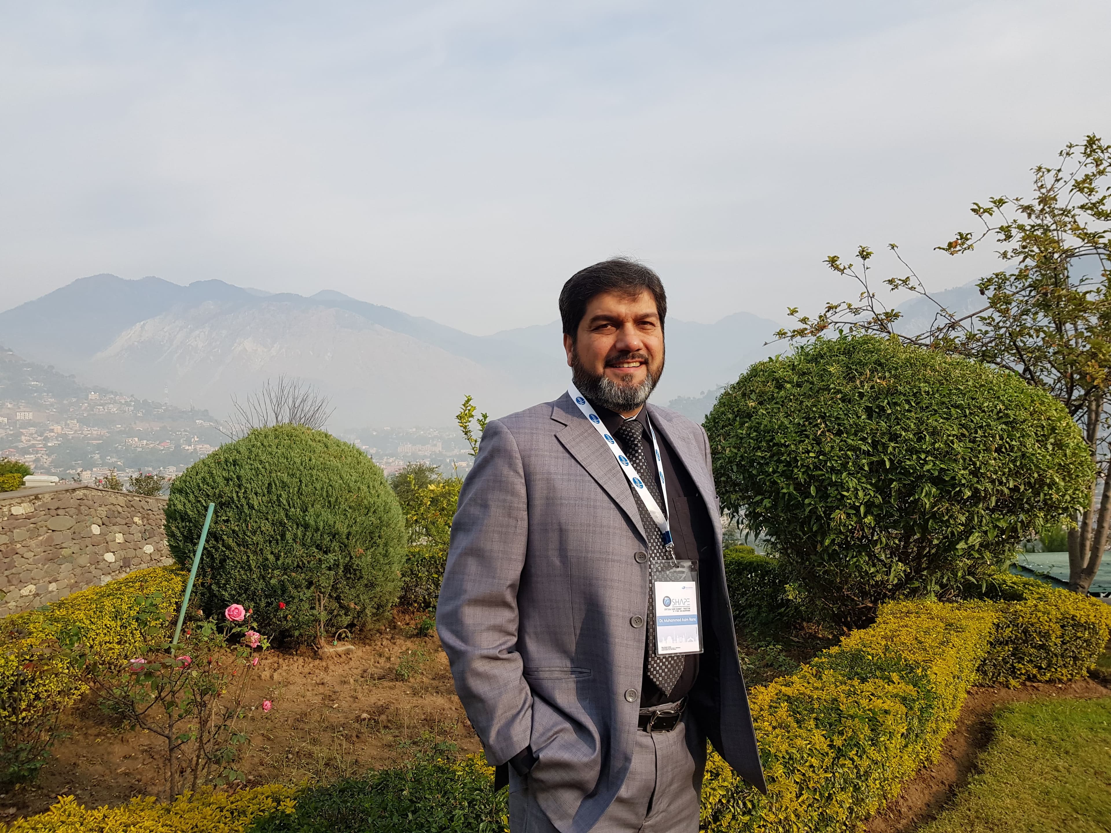 Dr. Asim Rana at the entrance of an intensive care and emergency medicine symposium