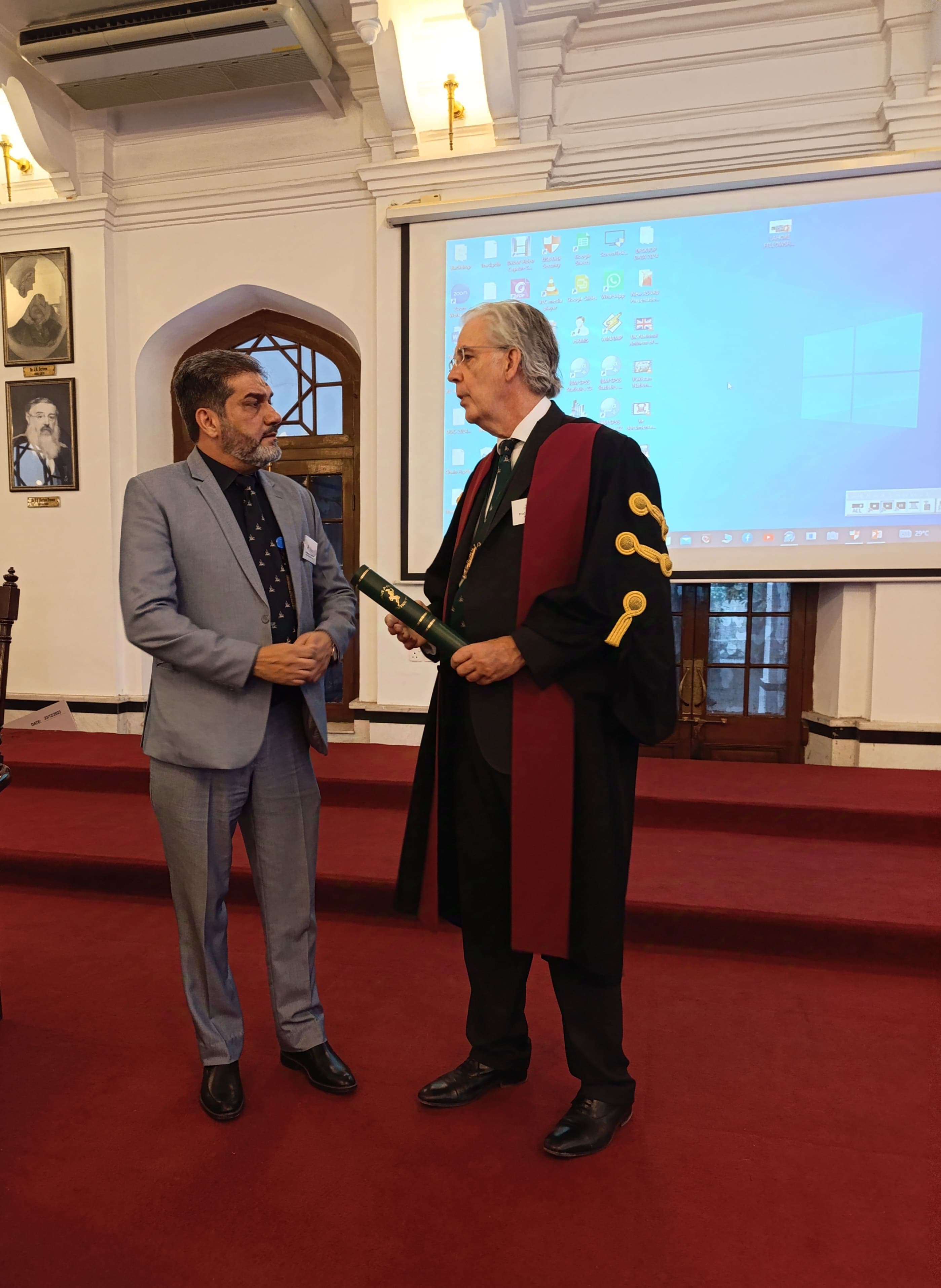 Dr. Asim Rana receiving his fellowship scroll at a medical convocation ceremony